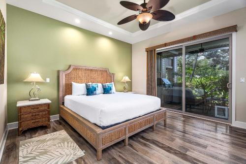 a bedroom with a bed and a ceiling fan at Kulalani at Mauna Lani 205 in Waikoloa