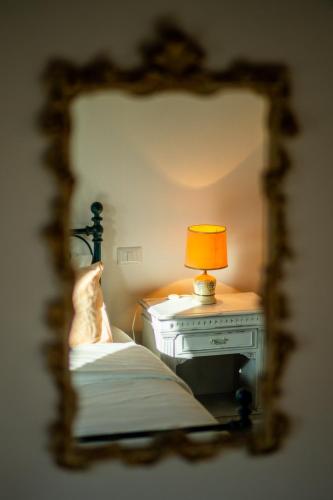 a bed with a table with a lamp on it at Agriturismo Anfora della Vita in Massa Marittima