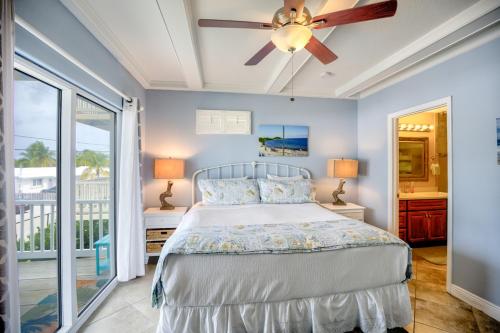 a bedroom with a bed and a ceiling fan at Florida Keys Wellness Gem in Marathon