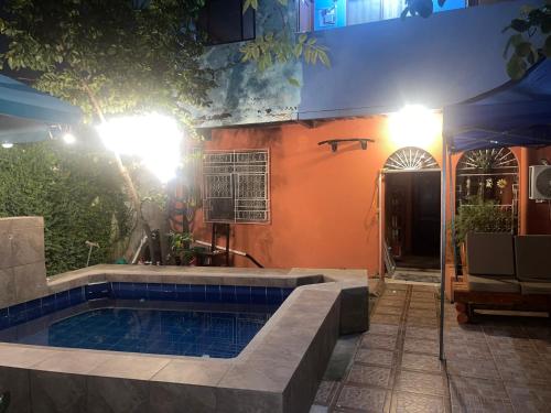 a house with a swimming pool at night at Funky Monkey in Guayaquil