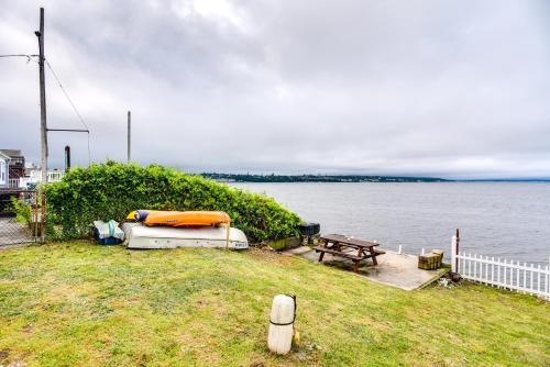a boat and a picnic table next to a body of water at Massachusetts Vacation Rental 5 Mi to Fall River in Somerset