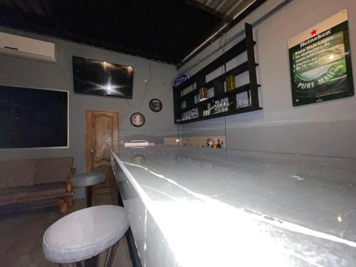 a bar with a white counter and a bar stool at Funky Monkey in Guayaquil