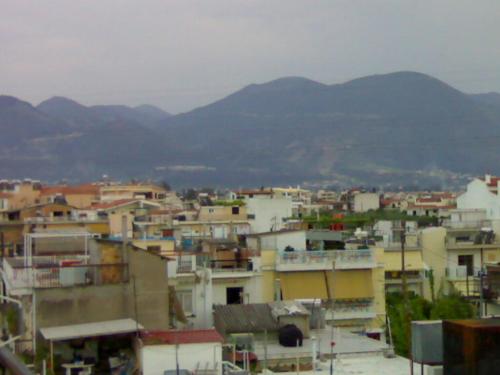 a group of buildings with mountains in the background at Gerard Luxury apartment in Patra