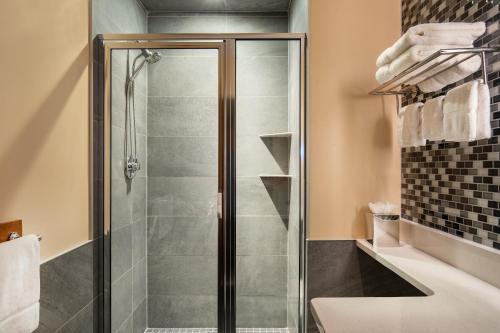 a bathroom with a shower with a glass door at Harborside Inn in Boston