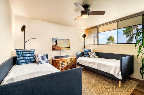 a bedroom with two beds and a ceiling fan at Country Club Villas 338 in Kailua-Kona