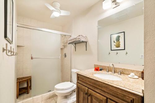 a bathroom with a toilet and a sink and a shower at Country Club Villas 338 in Kailua-Kona