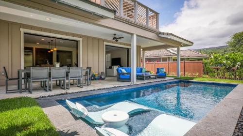 a swimming pool in front of a house at Holua Kai 2 in Kailua-Kona