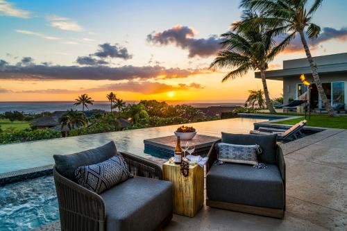 a villa with a view of the ocean at sunset at Hapuna Modern House at Mauna Kea in Hapuna Beach