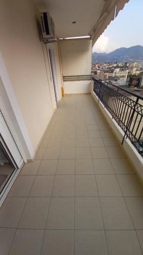 an empty balcony with a view of a city at Gerard Luxury apartment in Patra