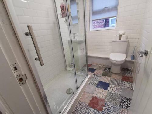a bathroom with a shower and a toilet at The Bob Marley 'One Love' Apartment, Relaxed Vibes in Liverpool