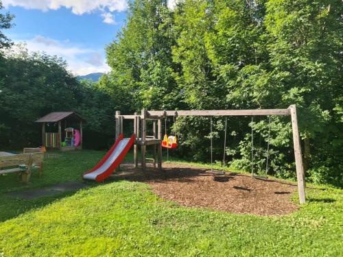 a playground with a slide in the grass at 4 Season Apartment Hermagor in Hermagor