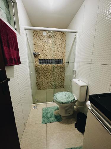 a bathroom with a shower with a toilet and a sink at Bangalô duplex 602 - Riviera do Atlântico in Conde