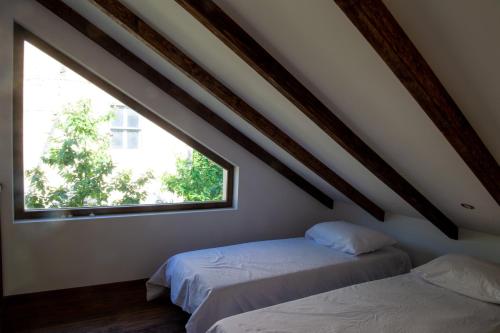 two beds in a room with a window at Walnut Cottage 1 in Deredzhik-Kʼoy