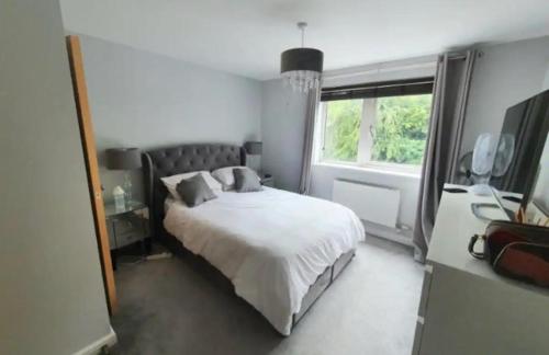 a bedroom with a white bed and a window at Escape Homestay 