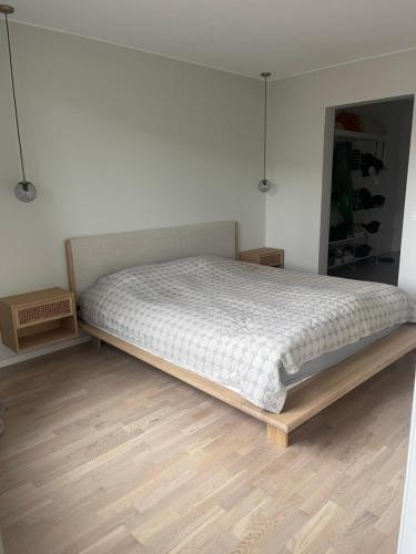 a bed in a bedroom with a wooden floor at New 4 bedroom apartment in Malmö in Malmö