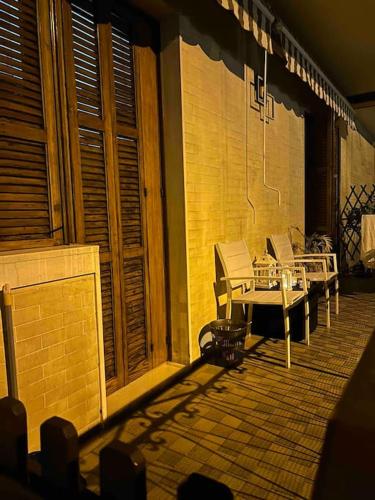 a patio with a table and chairs on a building at holy home in Mestre
