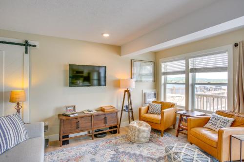 a living room with a couch and chairs and a tv at Gorgeous Onekama Condo with Pool and Lake Access! in Onekama