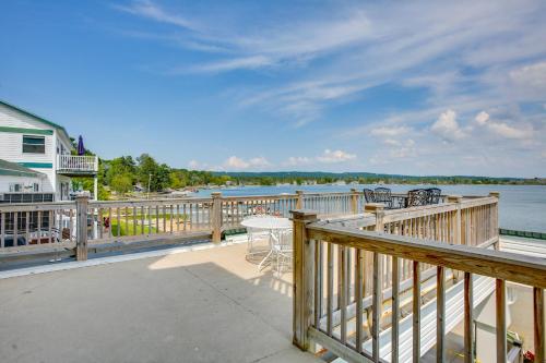 a balcony with a view of the water at Gorgeous Onekama Condo with Pool and Lake Access! in Onekama