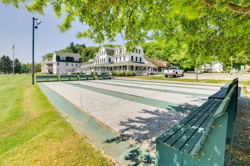 a green park bench in front of a building at Gorgeous Onekama Condo with Pool and Lake Access! in Onekama