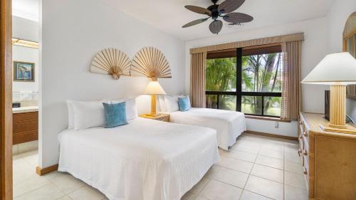 a bedroom with two beds and a window at The Shores at Waikoloa 117 in Waikoloa