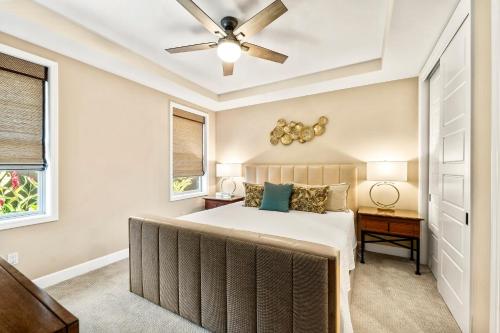 a bedroom with a bed and a ceiling fan at Holua Kai 37 in Kailua-Kona