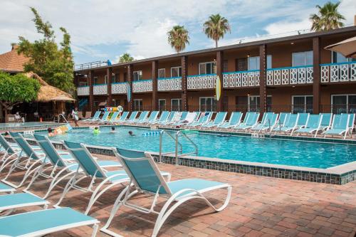 a swimming pool with chairs and a hotel at Westgate Cocoa Beach Resort in Cocoa Beach