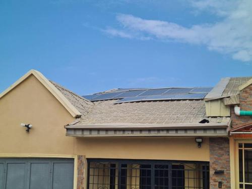 a house with solar panels on the roof at Chic 4 Bed bungalow Oluyole Akala express Ibadan in Ibadan