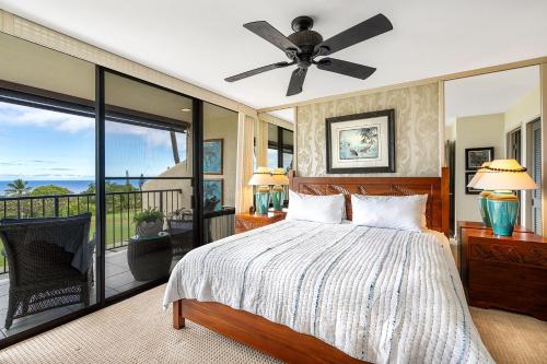 a bedroom with a bed and a ceiling fan at Country Club Villas 311 in Kailua-Kona