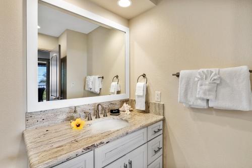 a bathroom with a sink and a large mirror at Country Club Villas 311 in Kailua-Kona
