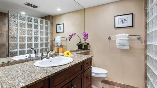 a bathroom with a sink and a toilet at Kona Pacific C520 in Kailua-Kona