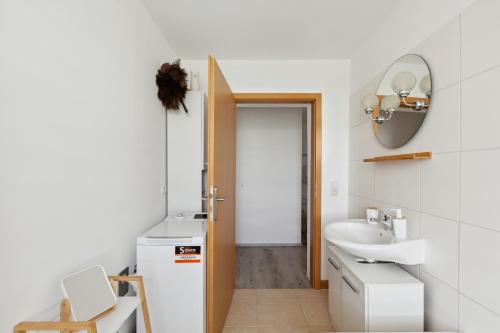 a bathroom with a sink and a mirror at Apartment-Studio, Netflix-TV für bis zu 2 Personen in Halberstadt
