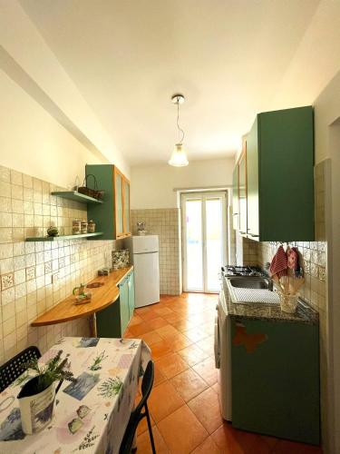 a kitchen with green cabinets and a counter top at Ammiragli Vatican Experience in Rome