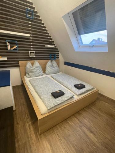 a bedroom with a bed with two pillows on it at #6 Familienzimmer mit Gemeinschaftsbad in Memmingen