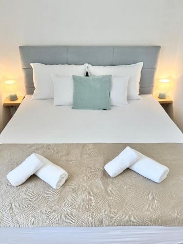 a bedroom with a bed with two pillows on it at Luxury apartment Aura in Supetar