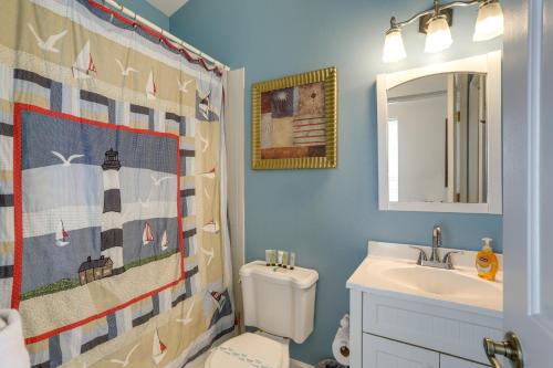 a bathroom with a sink and a toilet and a mirror at Indian Rocks Vacation Rental Condo Steps to Beach in Clearwater Beach