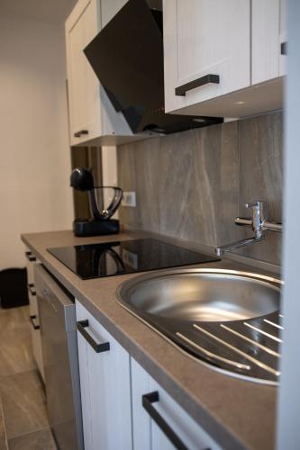 a kitchen with a sink and a counter top at Apartmani Vukman in Delnice