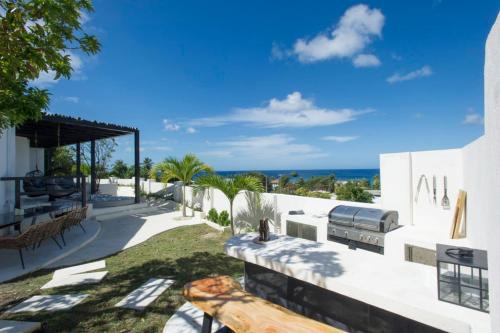 a white house with a view of the ocean at Dunn Dreamin Barbados in Saint James