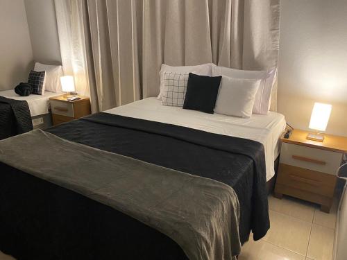 a bedroom with a large bed with two night stands at Prime Hotel in Arcos