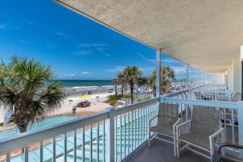 a balcony with chairs and a view of the beach at Daytona Beach Resort Oceanfront 1 Bedroom Suite, 2 Queen Beds in Daytona Beach