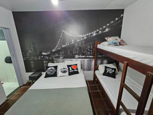 a dorm room with two bunk beds and a bridge at Pousada Tu Y Mar in Arraial do Cabo