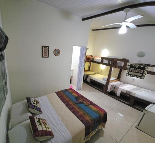 a bedroom with a bed and two beds in it at Pousada Tu Y Mar in Arraial do Cabo