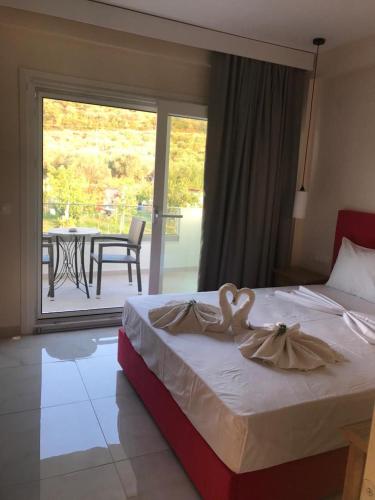 a bedroom with a bed with a swan decoration on it at NAMARE AQUA in Skala Sotiros