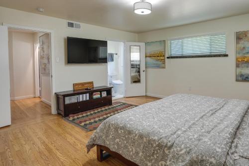 a bedroom with a bed and a flat screen tv at Stunning Bay-View Home in Kensington! in Kensington