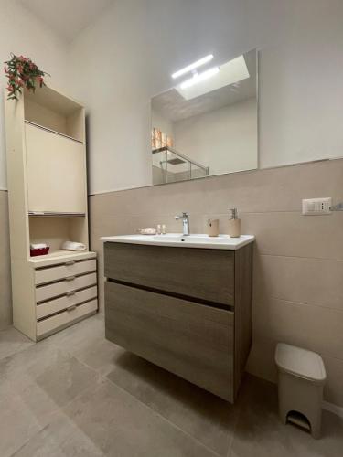 a bathroom with a sink and a mirror at Baia delle foche in Fertilia