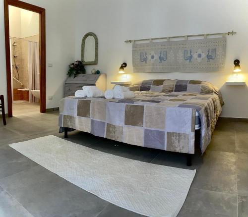 a bedroom with a large bed with two pillows on it at Baia delle foche in Fertilia