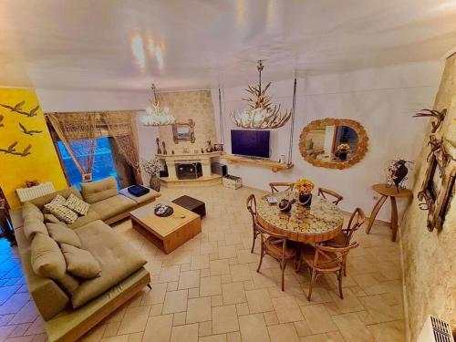 a living room with a couch and a table at Entire Villa with private pool in Skála