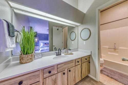 a bathroom with a sink and a large mirror at 1 Mi to Ski Slopes Alto Escape with Game Room! in Alto