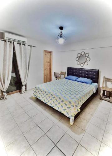 a bedroom with a large bed in a room at Villa Skala Atalantis in Skála