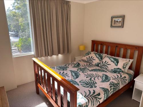a bedroom with a bed and a window at Beachpoint, Unit 101, 28 North Street in Forster