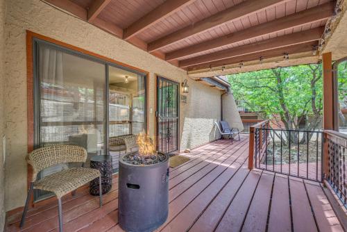 a porch with a fire pit on a deck at 1 Mi to Ski Slopes Alto Escape with Game Room! in Alto